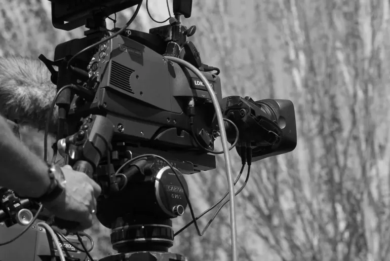 A person filming from left to right